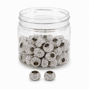 A clear plastic jar filled with silver-toned round beads covered in small clear rhinestones
