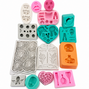 Assorted used silicone molds including rose, angel, dragonfly and character designs for DIY craft projects
