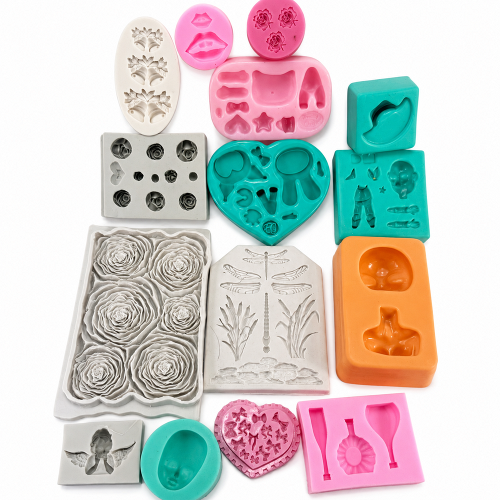 Assorted used silicone molds including rose, angel, dragonfly and character designs for DIY craft projects
