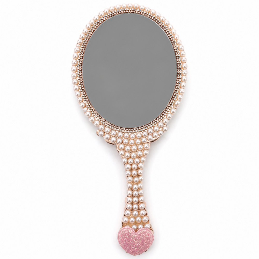 Back of pearl decorated hand mirror with gray reflective surface, rose gold trim and pink glitter heart handle