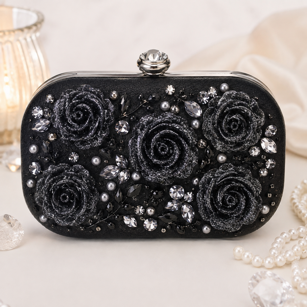 Black glitter rose cabochons decorating a black embellished clutch with crystals, pearls, and gothic glam details.