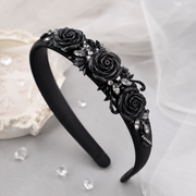 Black glitter rose cabochons decorating a black headband with crystals and elegant gothic-inspired accents.