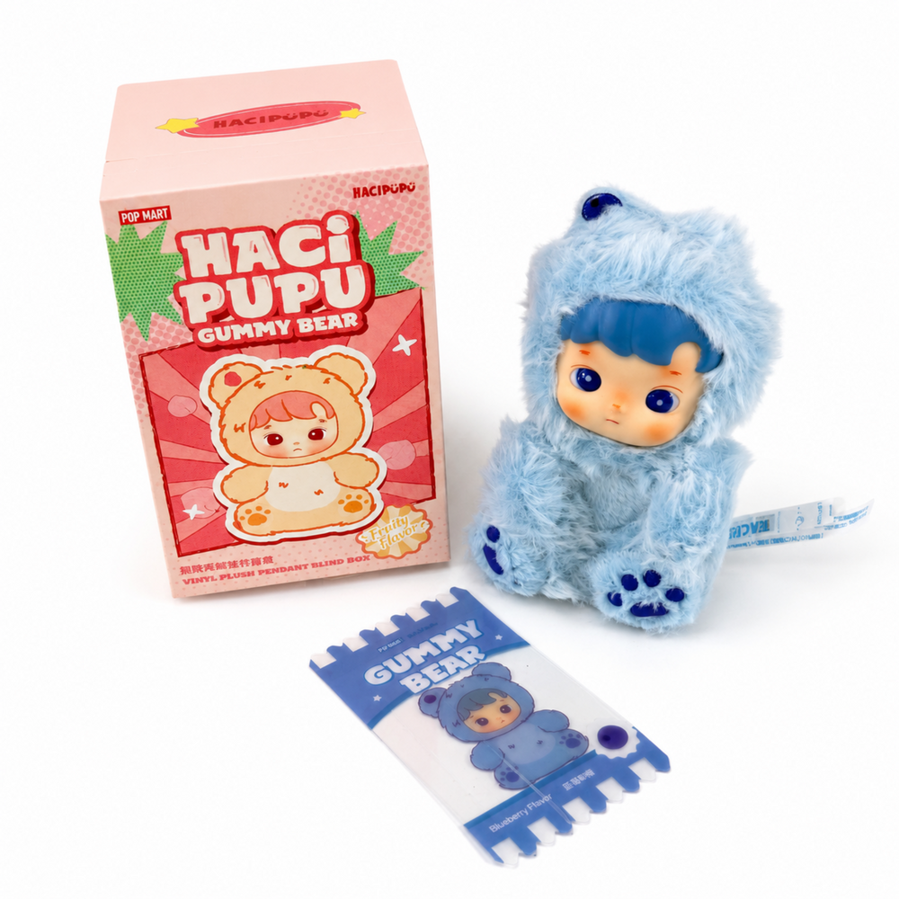 Blue Haci Pupu Gummy Bear plush pendant with fluffy bear outfit, paw details, box, and Blueberry Flavor insert.