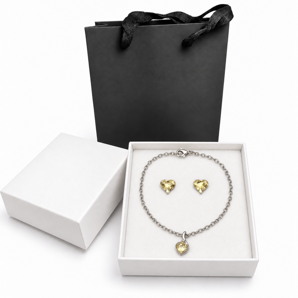 Champagne crystal heart necklace and matching earrings in a white jewelry box with a black gift bag.