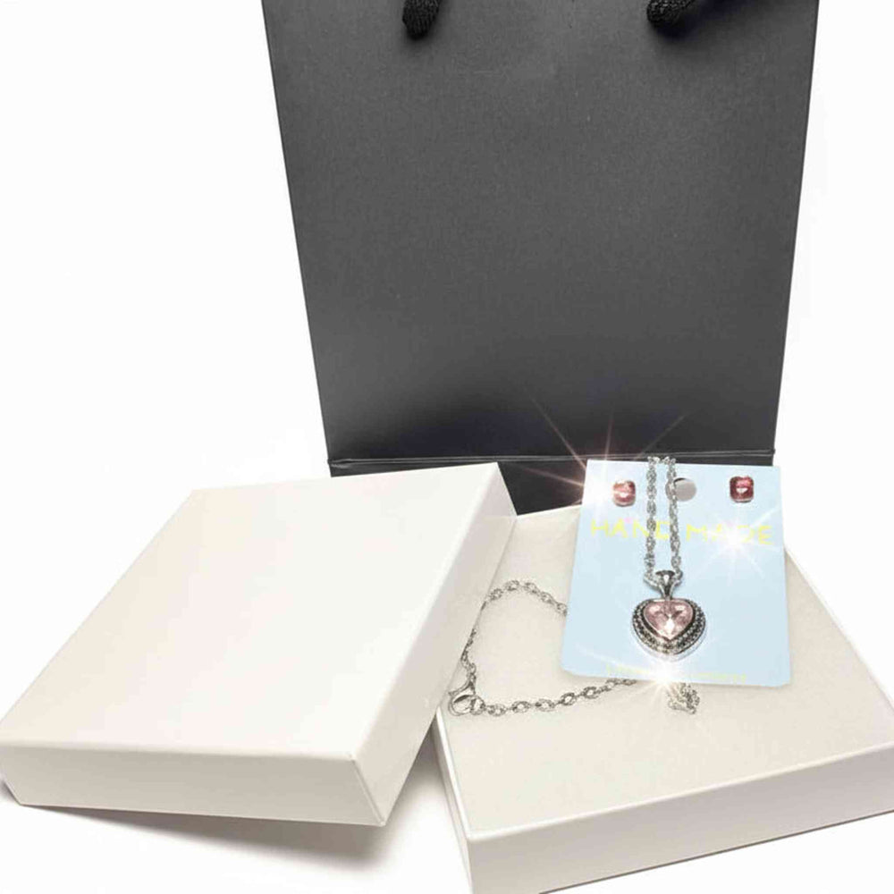 Close-up detail of rhinestone heart pendant and crystal  earrings jewelry set
