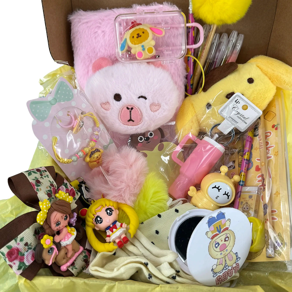 Close-up of a kawaii gift set with a plush pink journal, yellow bunny plush, pens, mini case, and cute accessories.