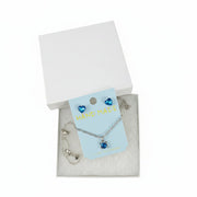 Close-up of blue crystal heart stud earrings with sparkling heart design