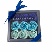 Close-up of blue ombre rose petal soap flowers in decorative gift box - luxury bath 
