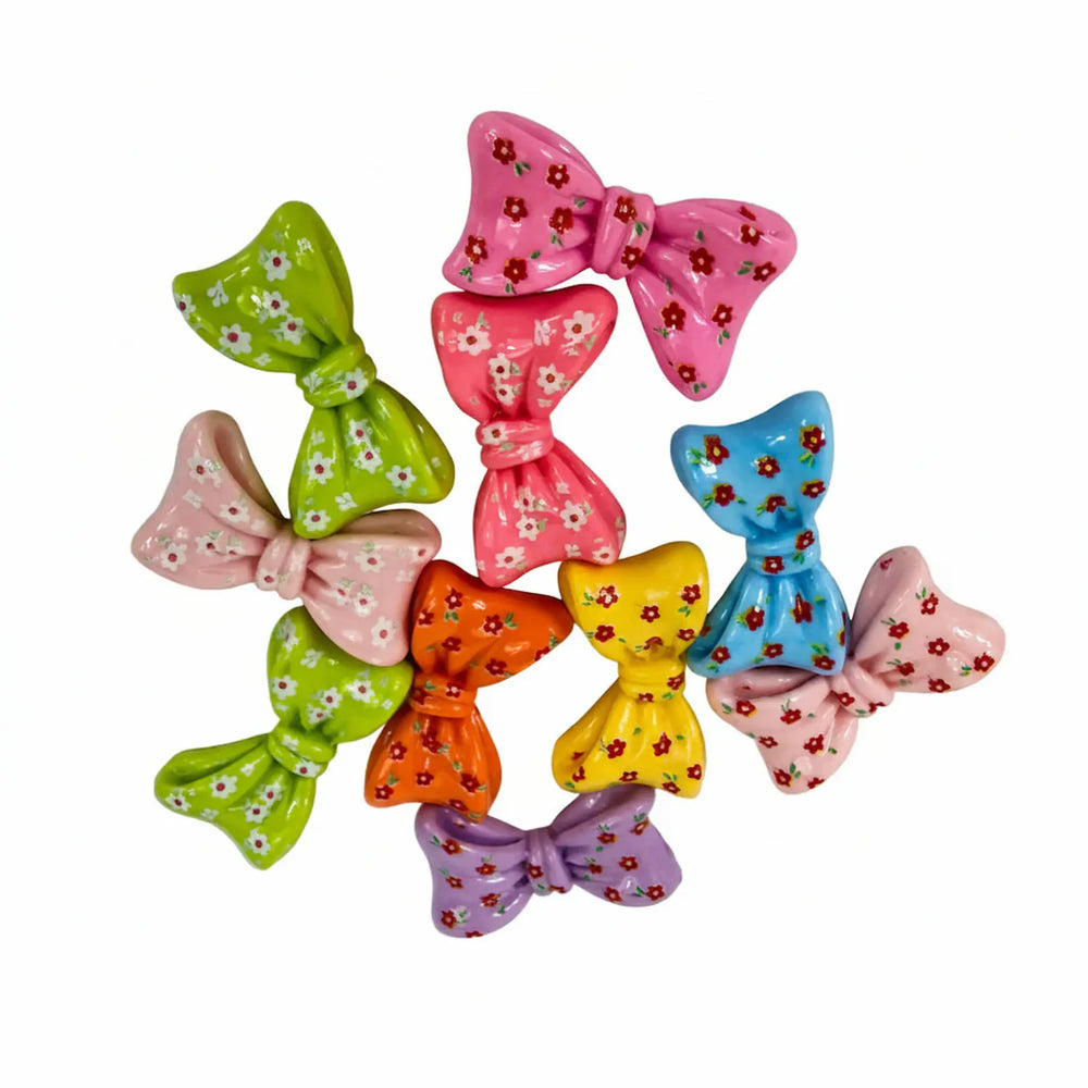 Close-up of colorful acrylic bow charms for scrapbooking and card making