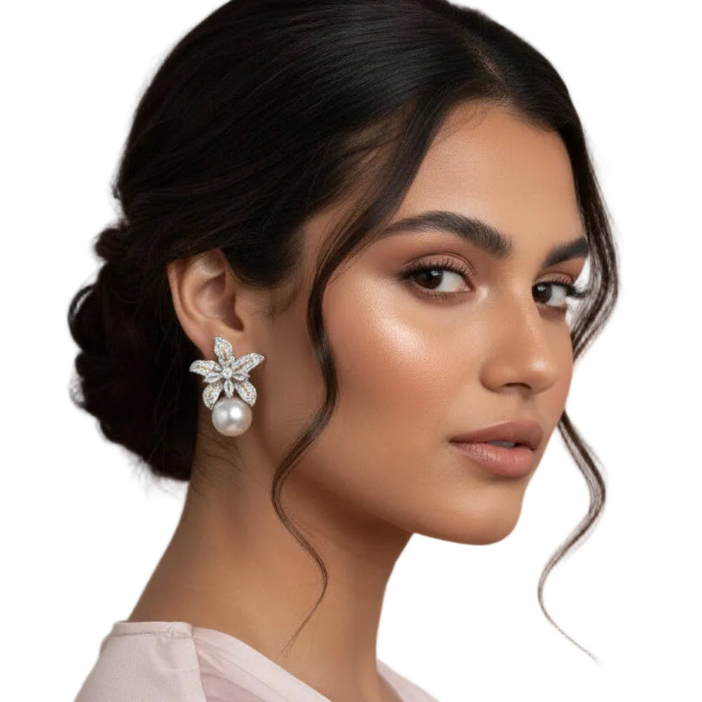 Close-up of faux pearl flower earrings with gold-tone details and sparkling crystal petals