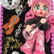 Close-up of hairbrush with handmade country singer porcelain doll playing guitar