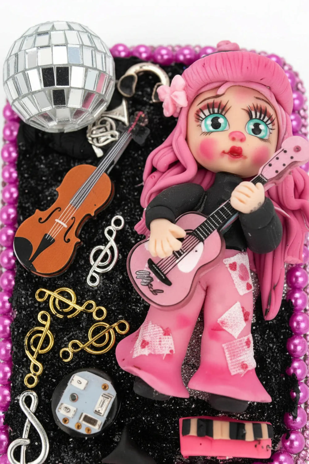 Close-up of hairbrush with handmade country singer porcelain doll playing guitar