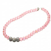 Close-up of handcrafted pet jewelry featuring high-quality pink faux pearls and professional finish