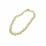 Close-up of handcrafted pet jewelry with yellow flower beads and smooth white pearls for small dog breeds