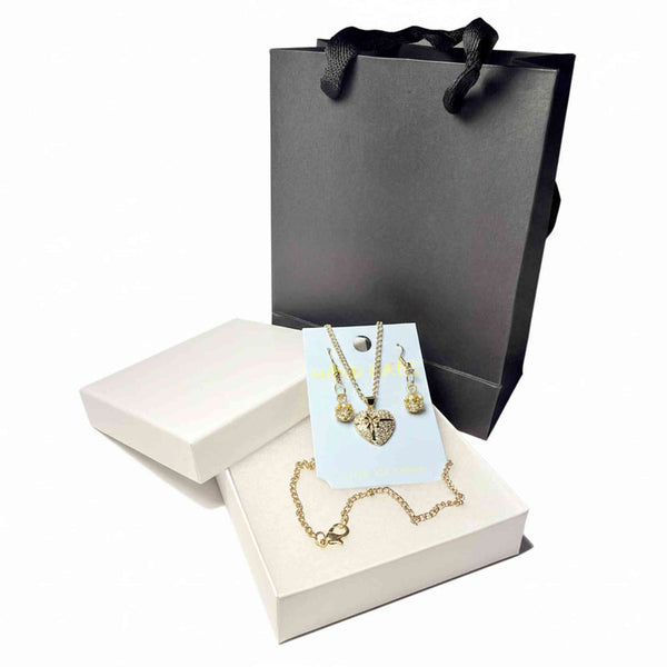 Close-up of rhinestone heart pendant necklace and crystal drop earrings set
