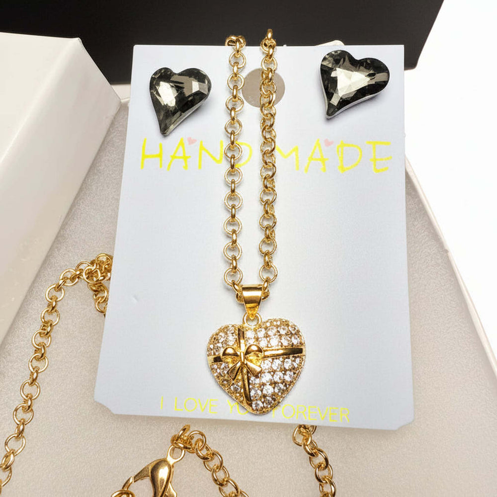 Close-up of rhinestone heart pendant necklace with sparkling crystal earrings - romantic jewelry gift set
