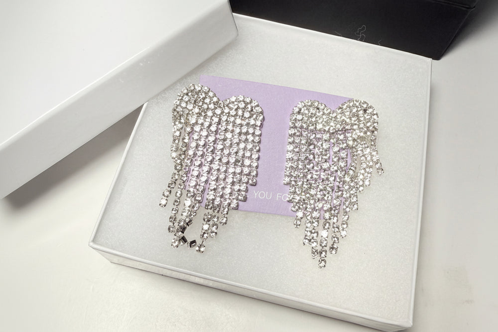 Close-up of sparkling rhinestone dangle earrings with a sophisticated cascading design for formal events