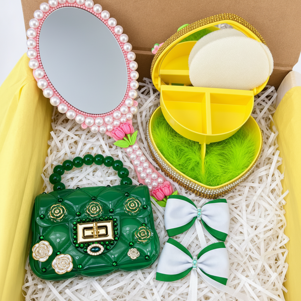 Coordinated handmade gift set with pink floral mirror, yellow heart trinket box, green handbag, two bows, and matching necklace and earrings in an open box.