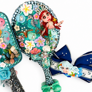 Crystal-decorated mermaid hand mirror with a red-haired doll, flowers, seashell details and a coordinating navy nautical hair bow.
