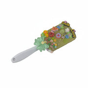 Cute decorated hairbrush with colorful resin charms, strawberries, stars, and a sweet mint green bow on the handle