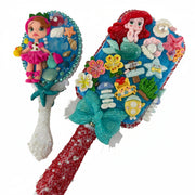 Decorated hair brush with ocean charms, sea shells, floral accents and clay doll mermaid theme