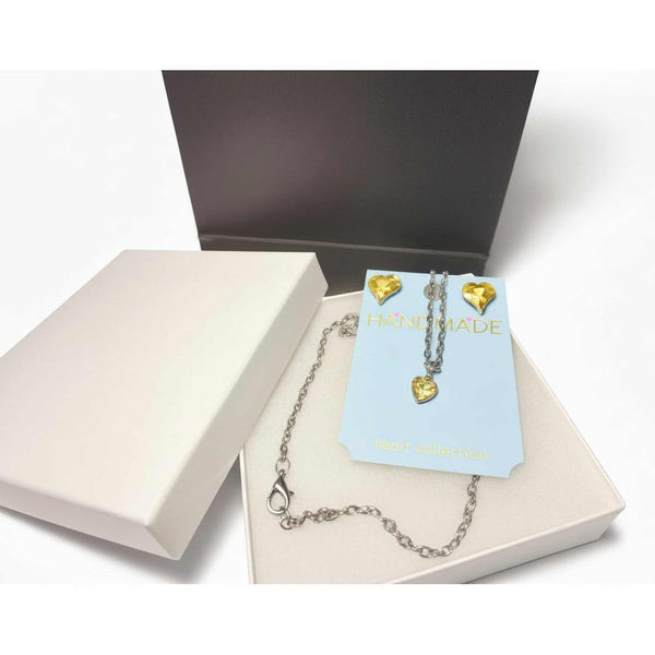 Detail view of rhinestone heart pendant necklace and crystal earrings jewelry set
