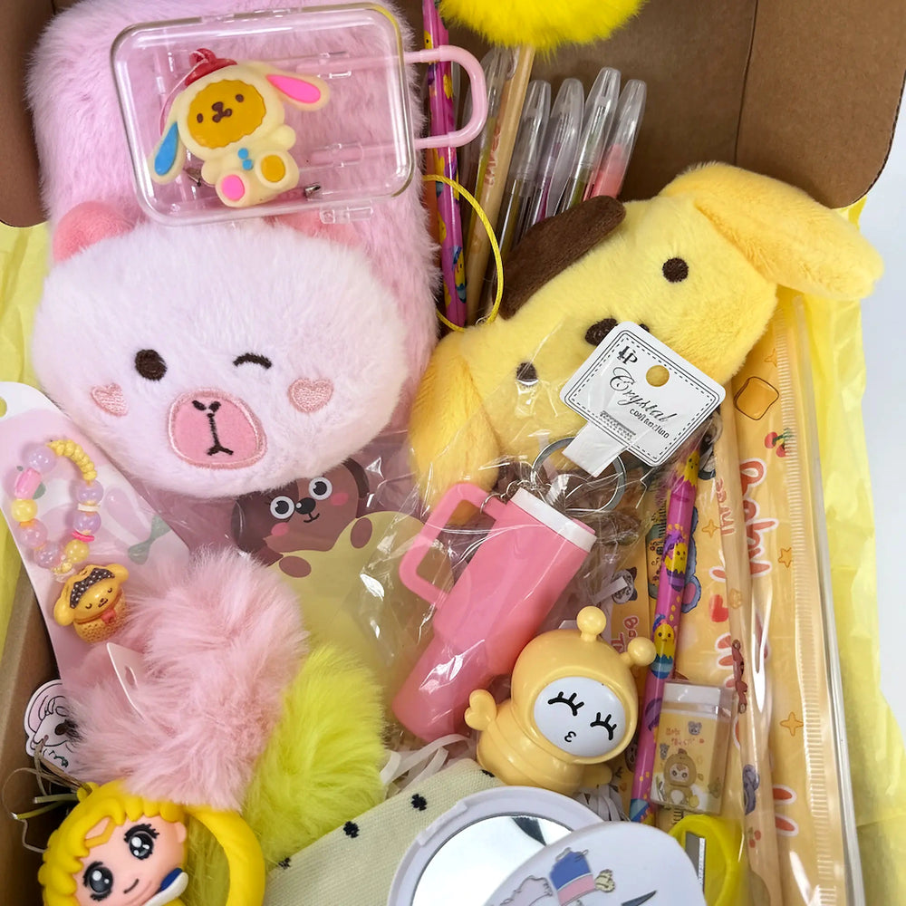 Detailed view of a kawaii gift set with a floral hair bow, anime-style keychain, pompom accents, and mirror.