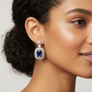 Elegant model wearing silver-tone crystal teardrop stud earrings, showcasing the classic teardrop shape and sparkling scale for weddings and formal events
