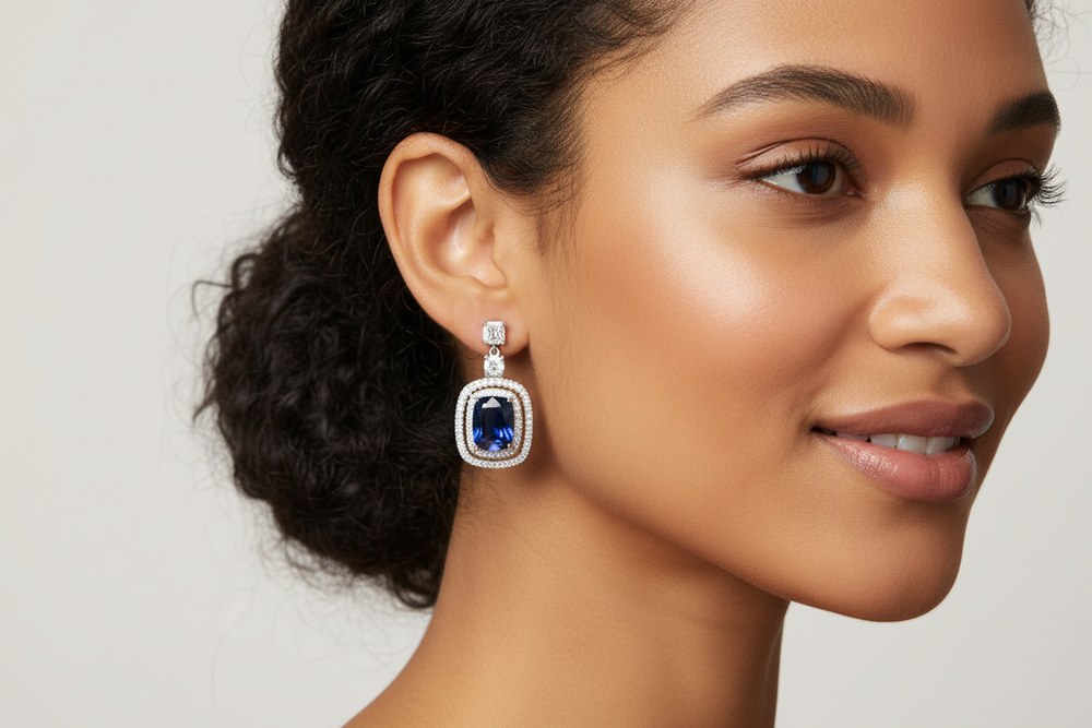 Elegant model wearing silver-tone crystal teardrop stud earrings, showcasing the classic teardrop shape and sparkling scale for weddings and formal events
