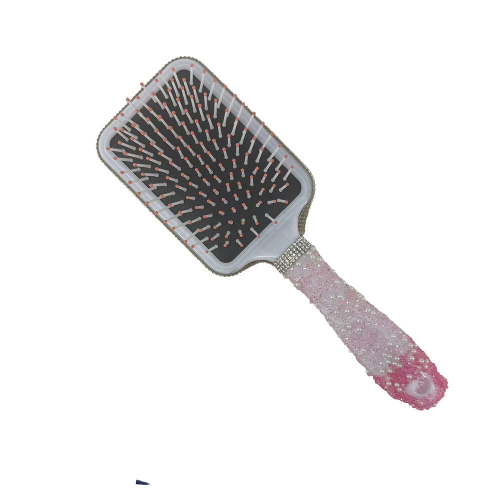 Elegant white paddle hair brush featuring a custom handmade pearlized finish handle and gray bristles