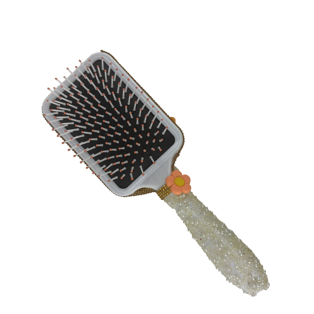 Elegant white paddle hair brush with a custom pearlized handle and a vibrant yellow glitter decoden design
