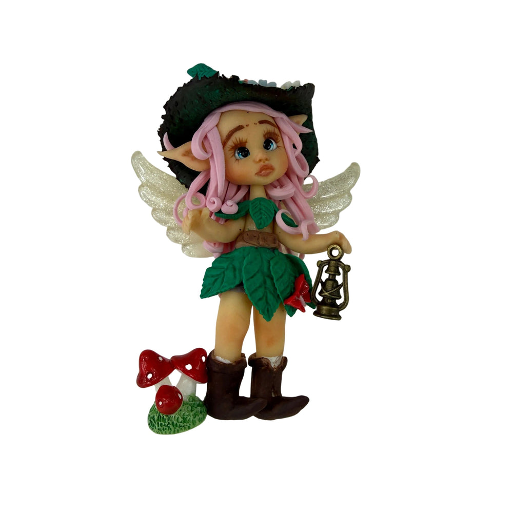 Elf figurine with pink hair, green outfit, and fairy wings 