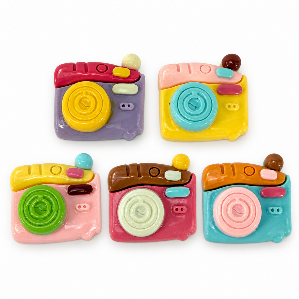 Five colorful 1-inch resin camera flatbacks in assorted pink, yellow, blue, purple, green, and brown designs