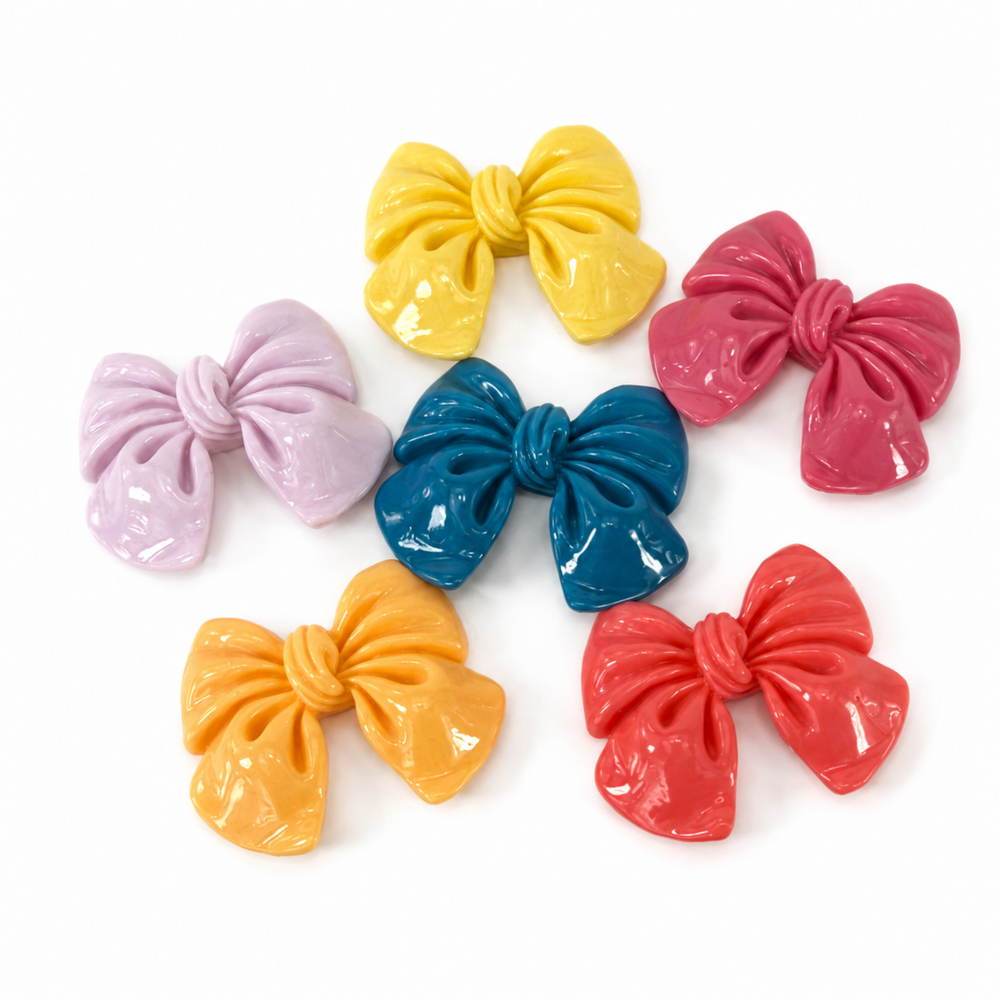 Five glossy resin bow flatbacks in assorted colors for DIY craft projects