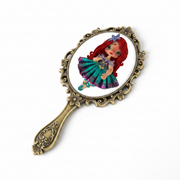 Flat back view of a kawaii princess flex porcelain planar doll placed on a decorative hand mirror