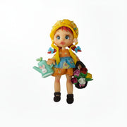 Flatback porcelain craft centerpiece featuring a cute cartoon girl gardener character holding a basket of pink roses