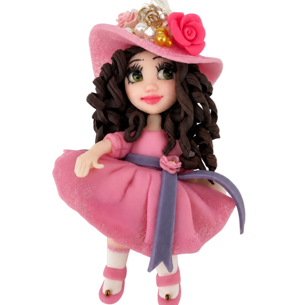 Flex porcelain fashion doll with green eyes, brown curls, pink glitter dress, lavender sash, and floral hat