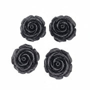Four black glittery rose-shaped stud earrings arranged in a 2x2 grid on a plain white background.