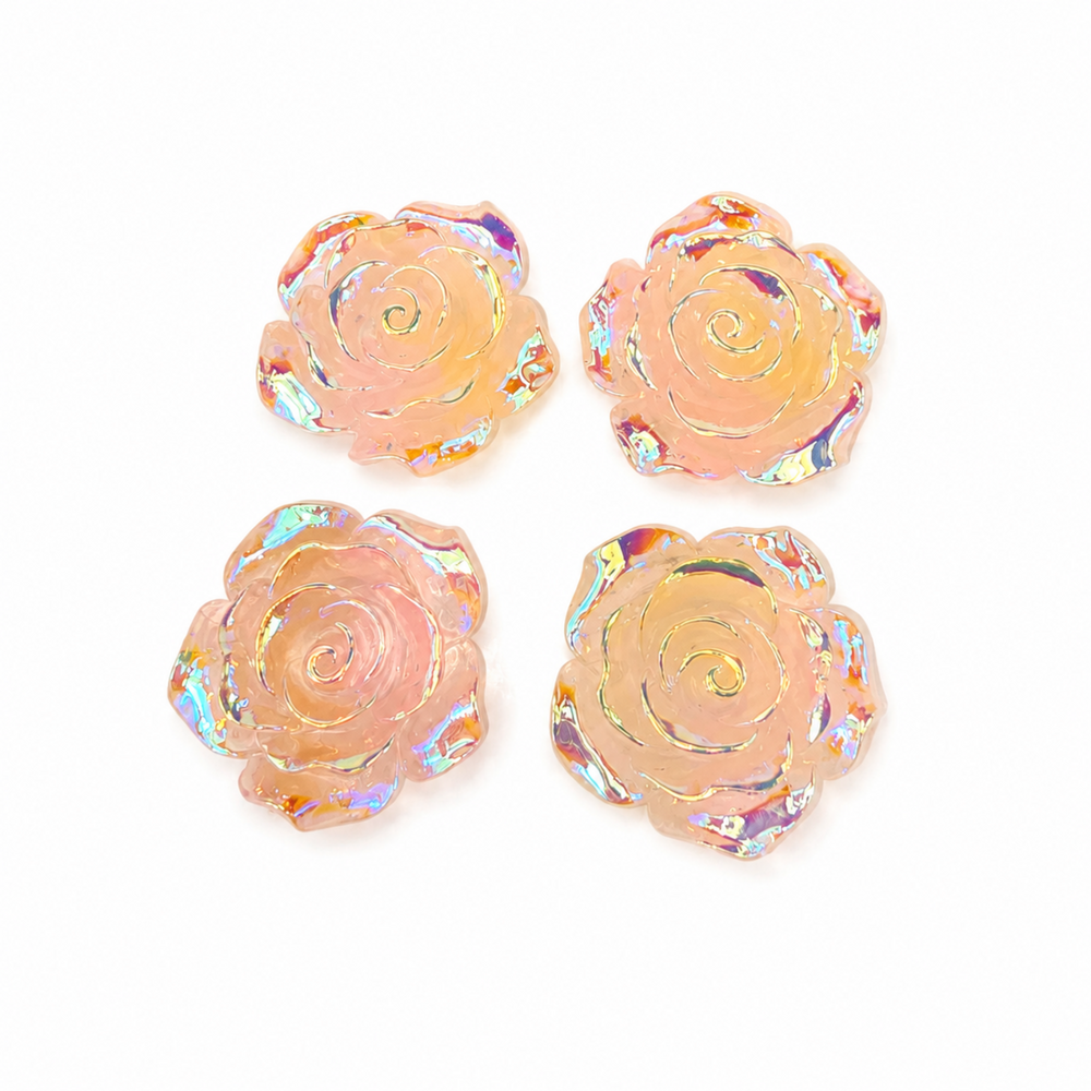 Four rose-shaped craft embellishments with an iridescent, holographic finish in a peach-pink color, arranged in a 2x2 grid on a white background.