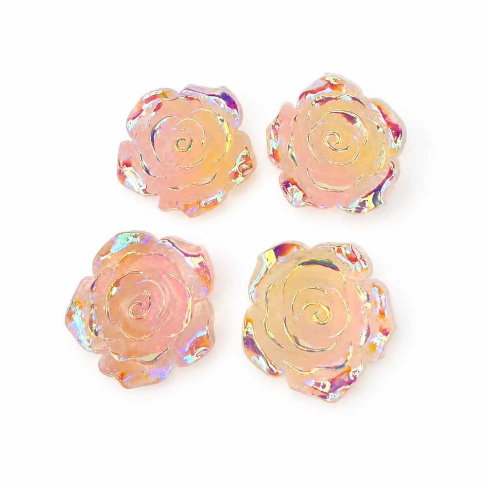Four rose-shaped iridescent resin cabochons in a soft peach-pink color, arranged in a 2x2 grid on a white background.