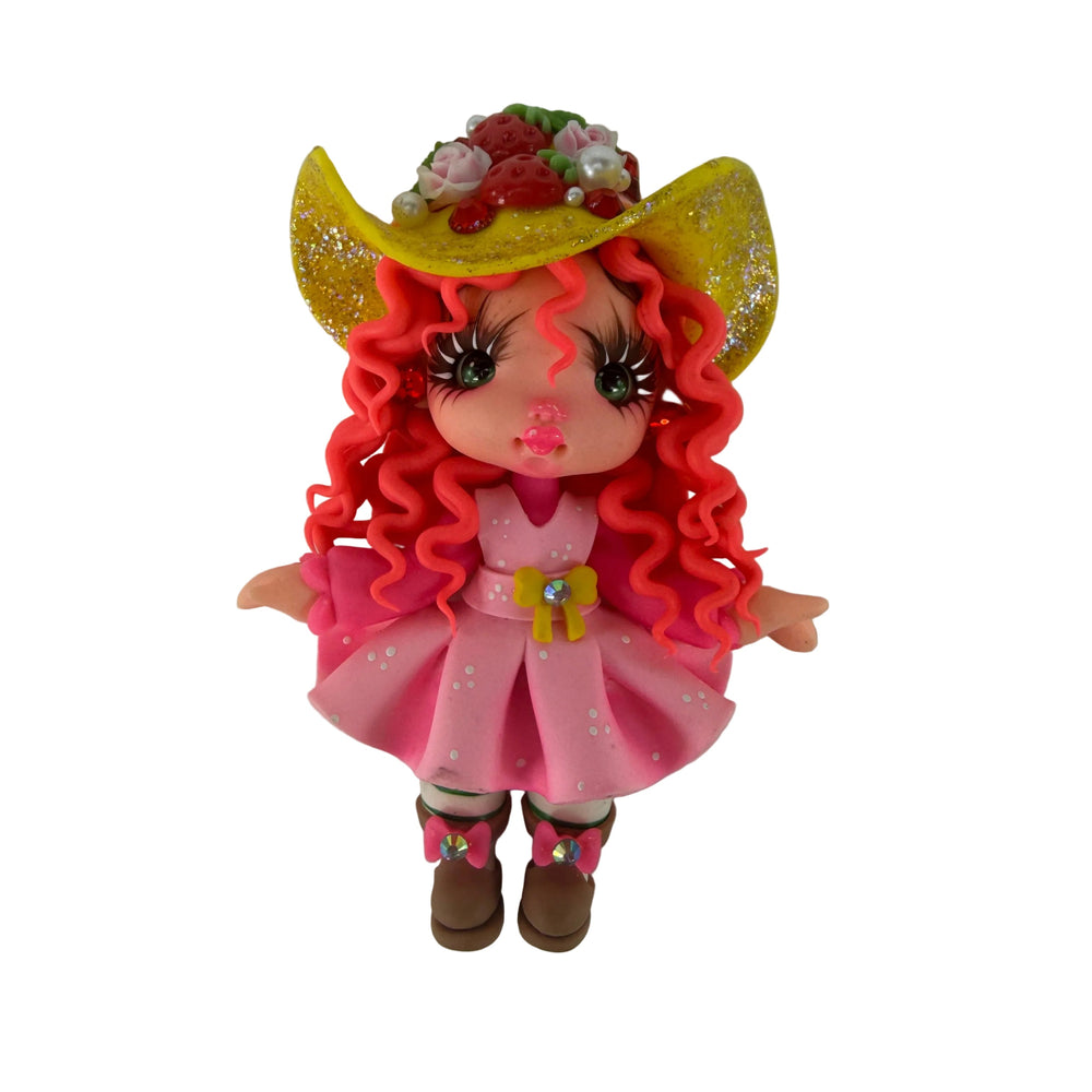 Front view of a flexible cold porcelain doll flatback with pink curly hair and cowboy hat for DIY crafts