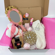 Glam & Glow spa gift set with vintage hand mirror, teddy bear towel, rhinestone purse charm, and bath bombs in a gift box