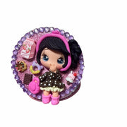 Glitter decorated compact mirror with clay doll figure on pink background