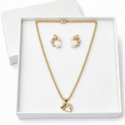 Gold necklace and matching stud earrings displayed in a white gift box. The necklace has a delicate gold chain with a small heart-shaped pendant, and the earrings feature white rose motifs with small clear stones.