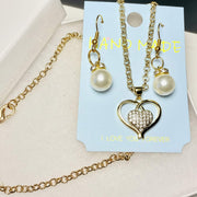 Gold tone heart necklace and faux pearl earring set in elegant gift box
