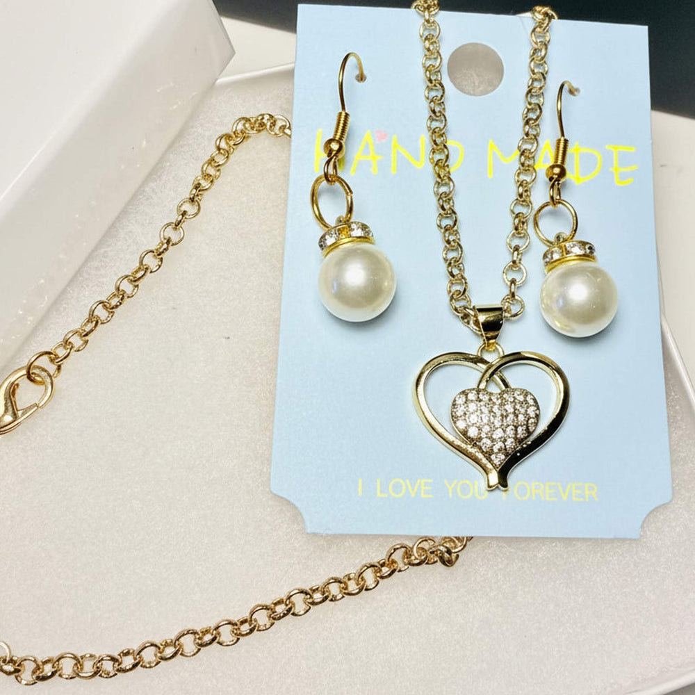 Gold tone heart necklace and faux pearl earring set in elegant gift box
