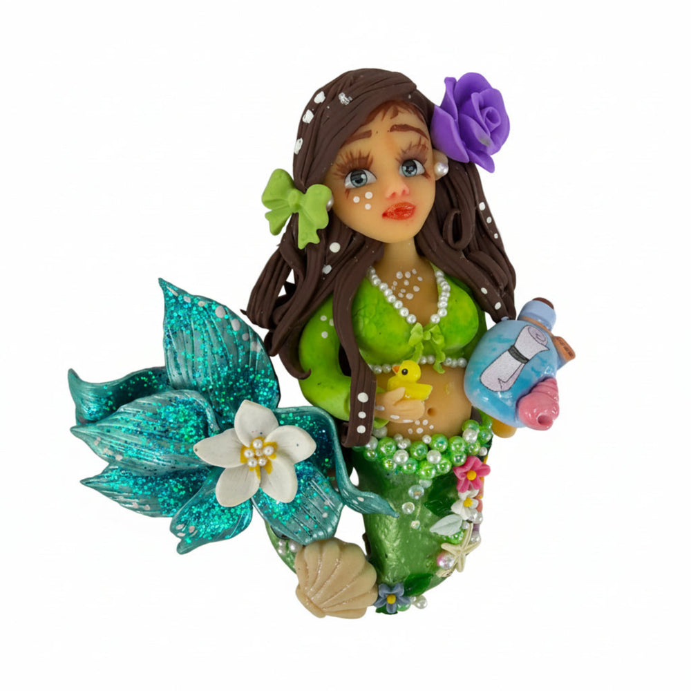 Handmade cold porcelain pregnant mermaid centerpiece with long brown hair, purple flower, and pastel blue tail