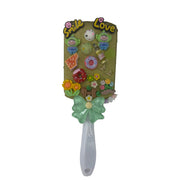 Handmade decoden paddle hair brush with colorful charms, flowers, donut, and 3D Smile and Love letters on white handle