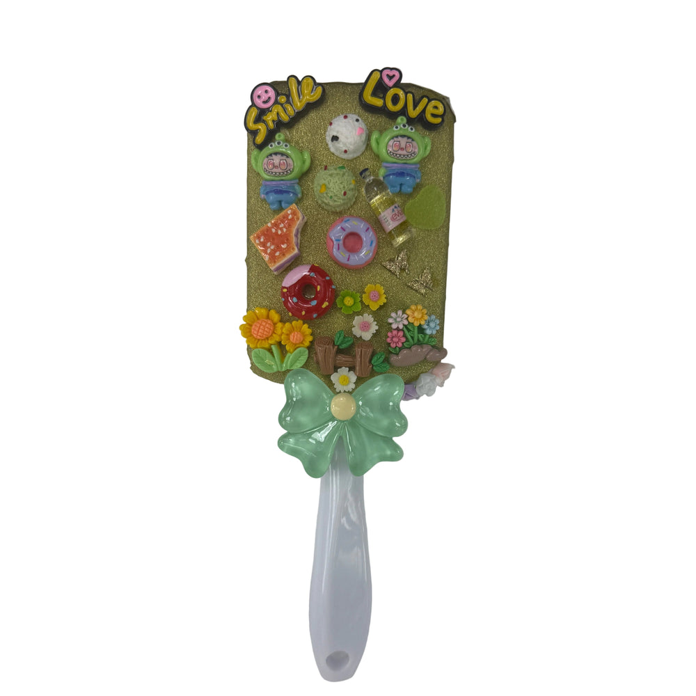 Handmade decoden paddle hair brush with colorful charms, flowers, donut, and 3D Smile and Love letters on white handle