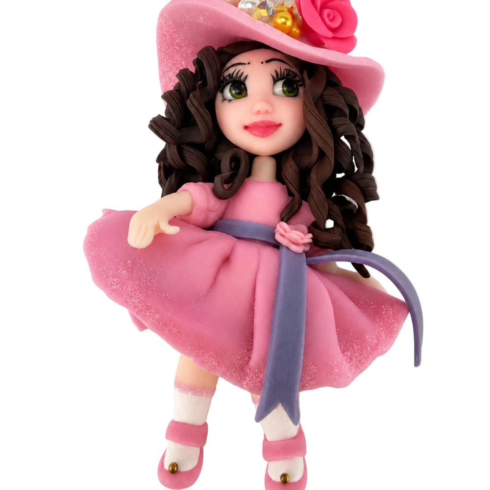Handmade doll figure with pink dress, pink shoes, and decorated floral hat